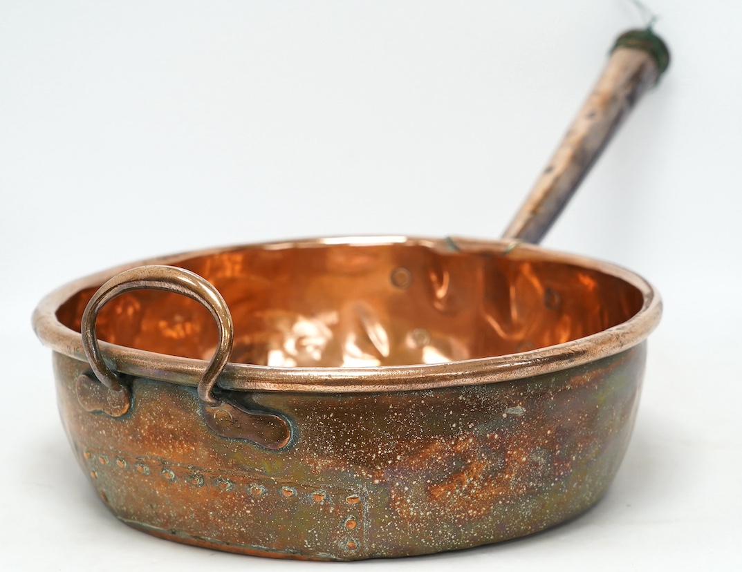 Two copper pans, one handled and the other with cover, 38cm diameter. Condition - fair